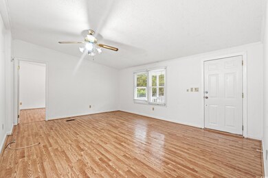 Unfurnished room with ceiling fan, vaulted ceiling