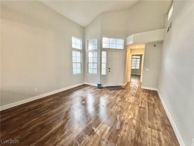Foyer entrance with wood finished floors and a tow