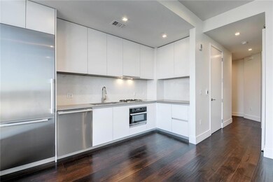 Kitchen featuring dark wood-style floors, white c