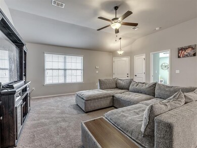 Living area featuring lofted ceiling, carpet floor