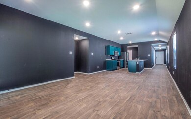 Kitchen featuring blue cabinets, open floor plan,