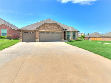 View of front of house featuring brick siding, a garage, driveway, a front lawn, and a shingled roof