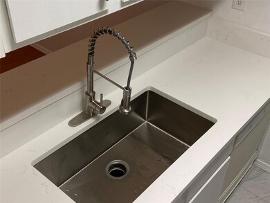 Interior details featuring sink and light tile flo