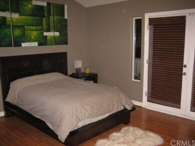 Another view of Master bedroom with wood floors an