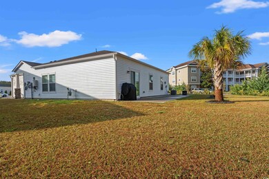 View of side of home with a lawn and a patio area