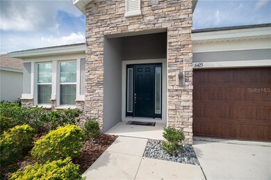 Stacked-stone covered entry w/upgraded glass-panel