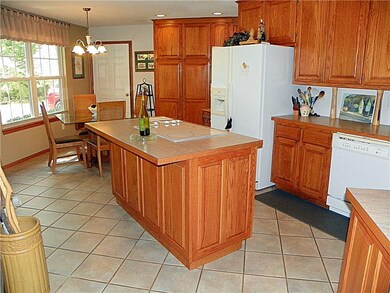 Wow~ this is a kitchen to write home about! Rich hardwood custom cabinetry, and lots of space to move around in.