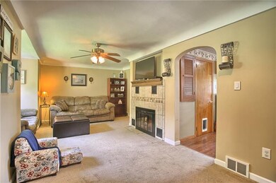 Entry way open to the living room with plush carpe