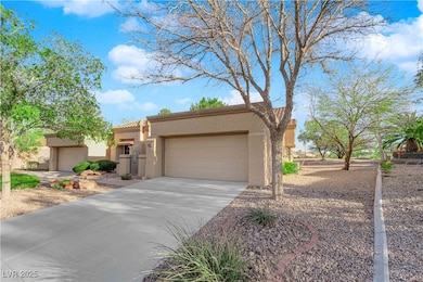 Adobe home featuring a tiled roof, a garage, drive