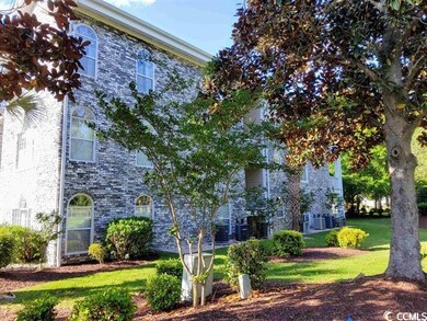 View of front facade with a front yard and brick siding