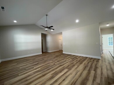 Unfurnished living room with ceiling fan, dark woo