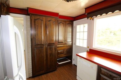 Pantry cabinet on left, cupboards and shelving on 