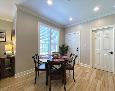Dining room with light wood-type flooring, baseboa