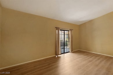 Empty room with wood finished floors and baseboard