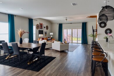 Dining room with dark wood-style floors and a ceiling fan