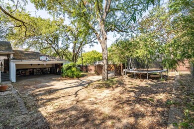 View of yard with fence and a trampoline