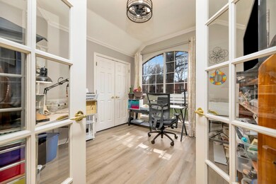 Office with laminate wood finished floors, ornamen