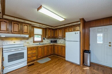 Kitchen featuring a textured ceiling, ventilation 