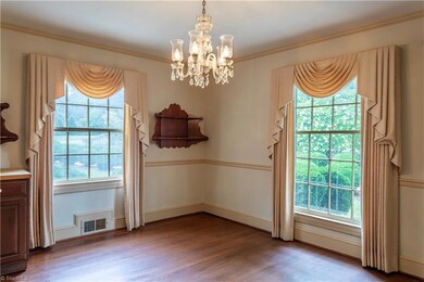 Formal dining room showcasing large windows, faces the front of the home.