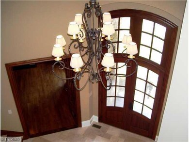 Entry. View from the upper balcony.  Solid Mahogany doors greet you at the entry.