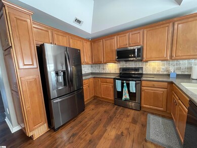 Kitchen has coffered ceiling and matching LG appli