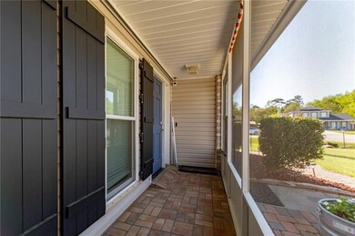 Screened in front porch, with storm shutters
