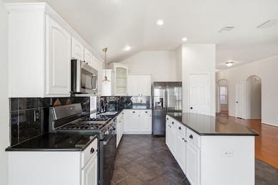 Granite counters with plenty of cabinet space.
