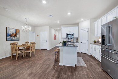 Kitchen with white cabinets, dark wood-type floor