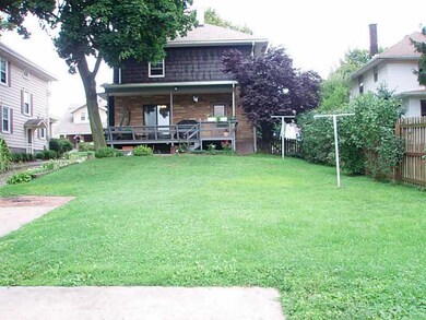 Exterior Back. Covered deck looks out to the level