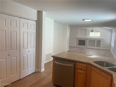 Kitchen with stainless steel dishwasher, brown cab