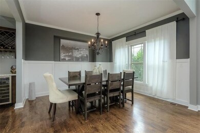 Formal Dining Room with wainscoting and bar area w
