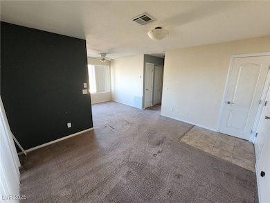 Unfurnished room featuring baseboards, carpet floo