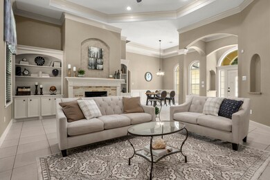 Formal living area with fireplace, trayed ceiling,