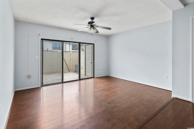 Spare room featuring baseboards, wood finished flo