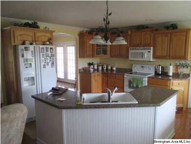 Kitchen has lots of counter space, sink in island/