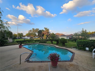 Pool with ample size deck and over size back yard.