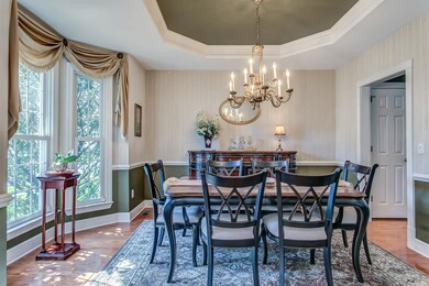 Formal Dining Room with bay Window, Trey Ceiling & Hardwood Floors.