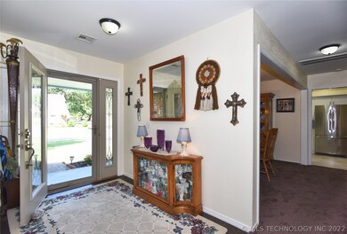 Entry way gives you a glimpse of the wood floor th