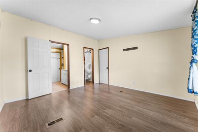 Unfurnished bedroom with a textured ceiling, visib
