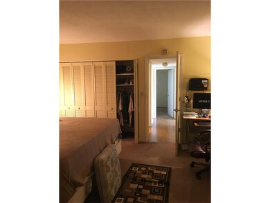 Master bedroom with glimpse of huge closet.