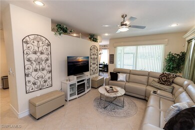 Living room with ceiling fan, light tile patterned