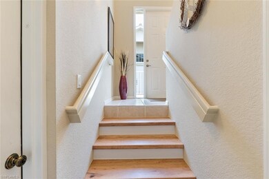 Upgraded real wood stairs lead you to the main liv