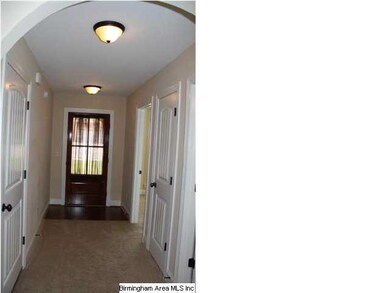 Hardwood and Carpet in the Foyer with Arched doorw