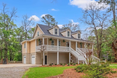 View of front facade with covered porch, driveway,