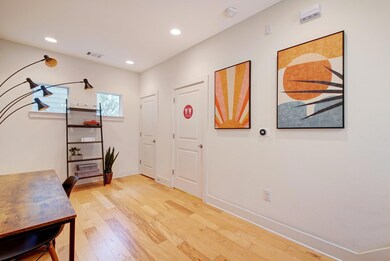 Foyer entrance featuring visible vents, light woo