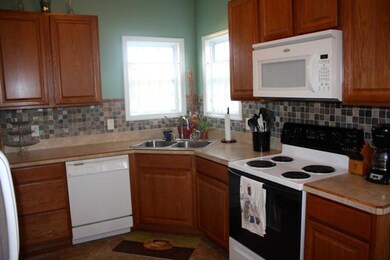 Kitchen with tile back splash. Refrigerator remains.