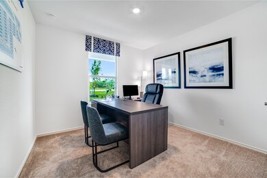 Office area with light colored carpet and baseboards