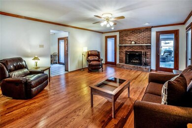 Family Room with fireplace, leading to sunroom and