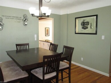 Formal dining room with hardwood floors.