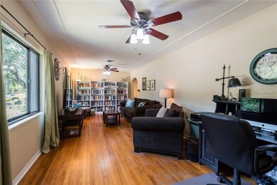 Gleaming hardwood floors and arched doorways in th
